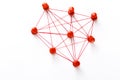 Network with red pins and string,  linked together with string on a white background suggesting a network of connections Royalty Free Stock Photo