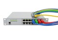 Network switch with multiple colored ethernet cables connected to ports, mounted on a rack Royalty Free Stock Photo