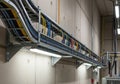 A network of variously colored cables, including blue, yellow, and red, runs through a metal cable Royalty Free Stock Photo