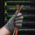 Network wires in the hands of a man at the server for data storage, clo Royalty Free Stock Photo
