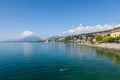 Neuchatel,Switzerland-Sept.05.2018:Neuchatel lake in Switzerland seen from the port promenade of Estavayer-le-Lac, with plants and Royalty Free Stock Photo