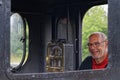 Portrait of man operating old steam train