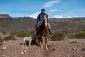 Neuquen, Argentina, July 21, 2021; Argentine cowboy gaucho walks his horse past camera, in Patagonia.in Patagonia