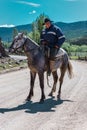 Neuquen, Argentina, November 21, 2021; Argentine cowboy gaucho walks his horse past camera, in Patagonia