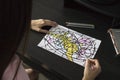Neurographics, A woman draws a neurographic drawing on paper with pencils. Working with the subconscious, taking care of