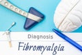 Neurological diagnosis of Fibromyalgia. Neurological hammer, human brain figure, tools for sensitivity testing are on table next t