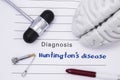 Neurological diagnosis of Huntington`s disease. Neurological hammer, human brain figure, tools for sensitivity testing are on tabl Royalty Free Stock Photo