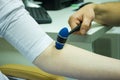 Neurological physical examination of the elbow flexion reflex. Doctor neurologist with a rubber neurological hammer in his hand ch Royalty Free Stock Photo