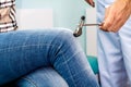 Neurologist checks reflexes hammering knee. Royalty Free Stock Photo