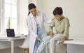 Neurologist examining happy child and using medical hammer to check his knee reflex Royalty Free Stock Photo