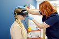 Neurologist performing positional testing of patient using videonystagmography . VNG testing uses goggles with infrared cameras to