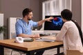 Neurologist showing brain scan to young woman in clinic Royalty Free Stock Photo