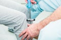 The neurologist testing knee reflex on a female patient using a hammer. Neurological physical examination. Selective focus, close Royalty Free Stock Photo