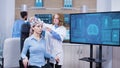 Neurology female doctor making adjustments to brainwaves headset