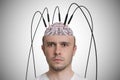 Neuroscience and brain research concept. Young man has cables and electrodes in his brain Royalty Free Stock Photo