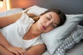 Neuroscientific importance of a good sleep. Young beautiful woman sleeps blissfully in the bed. Girl with regulated circadian Royalty Free Stock Photo