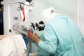 A neurosurgeon doctor looks into a microscope during an operation. Neurosurgery and microsurgery.