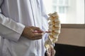 A neurosurgeon pointing at lumbar vertebra model in medical off