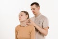 Neurosurgeon puts cervical soft collar or neck brace bandage on young woman to support and immobilize neck or for treat