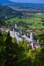 Neuschwanstein castle on Alps background in vicinity of Munich, Bavaria, Germany, Europe. Autumn landscape with castle Royalty Free Stock Photo