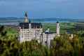 Neuschwanstein castle on Alps background in vicinity of Munich, Bavaria, Germany, Europe. Autumn landscape with castle Royalty Free Stock Photo
