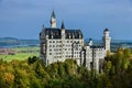 Neuschwanstein castle on Alps background in vicinity of Munich, Bavaria, Germany, Europe. Autumn landscape with castle Royalty Free Stock Photo