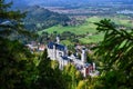 Neuschwanstein castle on Alps background in vicinity of Munich, Bavaria, Germany, Europe. Autumn landscape with castle Royalty Free Stock Photo