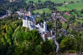 Neuschwanstein castle on Alps background in vicinity of Munich, Bavaria, Germany, Europe. Autumn landscape with castle Royalty Free Stock Photo