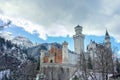 Neuschwanstein castle in beautiful frozen winter landscape with clouds and sunshine Royalty Free Stock Photo