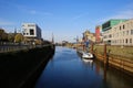 View on old historic inland loading port landing pier with vessel on rhine river, cranes and factories