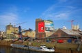 View on old historic inland loading port landing pier with vessel on rhine river, cranes and factories