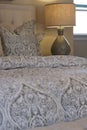 Neutral Bed Linens & Lamp Royalty Free Stock Photo