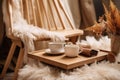 Neutral breakfast still life scene. Blank greeting card, ceramic plate. Vase with dry lagurus bunny tail grass on book