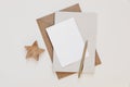 Neutral Christmas stationery. Blank greeting card, invitation and diary mockup template. Craft envelope, golden ball pen