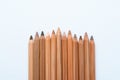 Neutral color skin pencils aligned on a white canvas