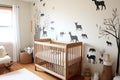 a neutral-colored nursery with wooden crib and animal wall decals