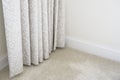 Neutral colour home interior showing curtains and carpet