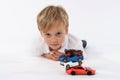 Neutral and innocent look of a kindergarten child after playing with a car toys Royalty Free Stock Photo