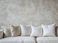 Neutral Interior Scene: Sofa With Cushions And Textured Plaster Wall, Minimalist Design Royalty Free Stock Photo