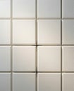Neutral square tiled wall with raised panels Royalty Free Stock Photo