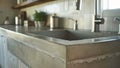 The neutral yet striking surface of the polished concrete countertop complements a minimalist kitchen perfectly. Its