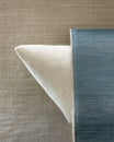 Soft fabric textures with a neutral-toned pillow and a blue accent cover on a light backdrop Royalty Free Stock Photo