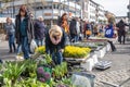 Many female customers are interested in flowers and other plants offered at a spring garden market