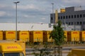 DHL delivery vans and containers in front of a DHL depot Royalty Free Stock Photo