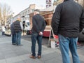 Neuwied, Germany - March 26, 2021: Male customers with face masks due to the corona pandemic standing in a row on a farmer`s marke