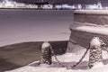 Neva river embankment and chain link fence in St. Petersburg in winter Royalty Free Stock Photo