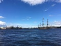 The Neva River with the sailing ship Poltava and warships lined up for the naval parade in St. Petersburg against the background Royalty Free Stock Photo