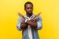 Never again. Portrait of absolutely convinced man crossing hands, showing x sign. indoor studio shot isolated on yellow background Royalty Free Stock Photo