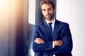 Never beg for what you can earn. Portrait of a businessman standing in his office. Royalty Free Stock Photo