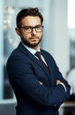 Never doubt your dreams. Portrait of a well-dressed businessman standing in a office.